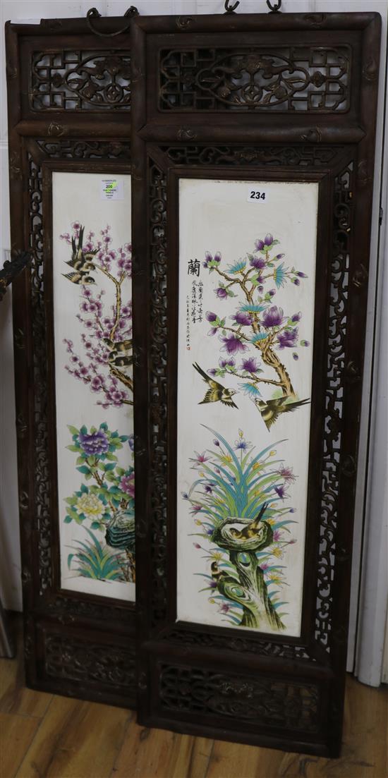 A pair of Chinese porcelain panels, in carved wood frames panels 75 x 21cm